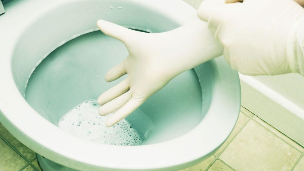 Clearing Toilet Tank With Rubber Glove