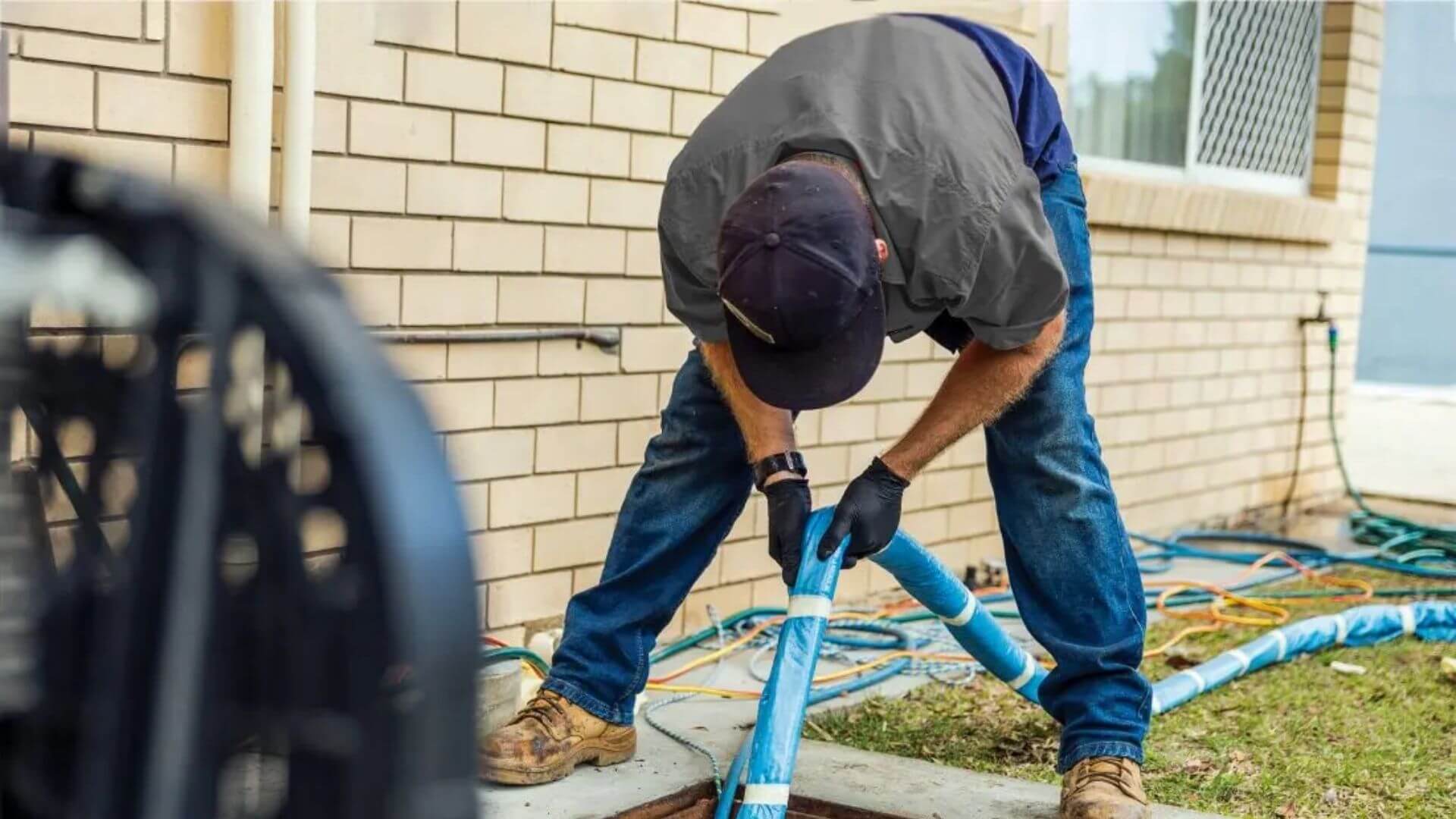 Professional Plumber Performing Pipe Relining At Residential Property