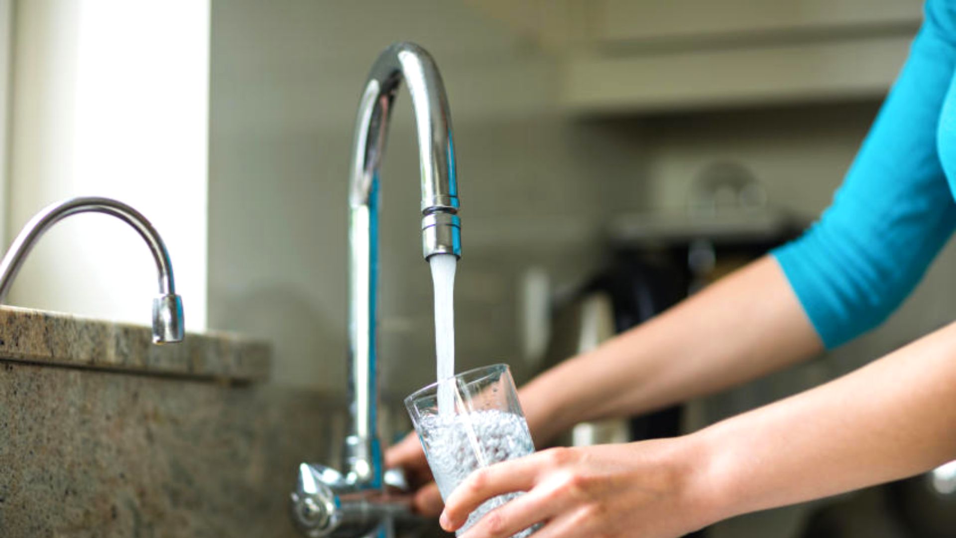 Person Getting A Glass Of Filtered Tap Water 1