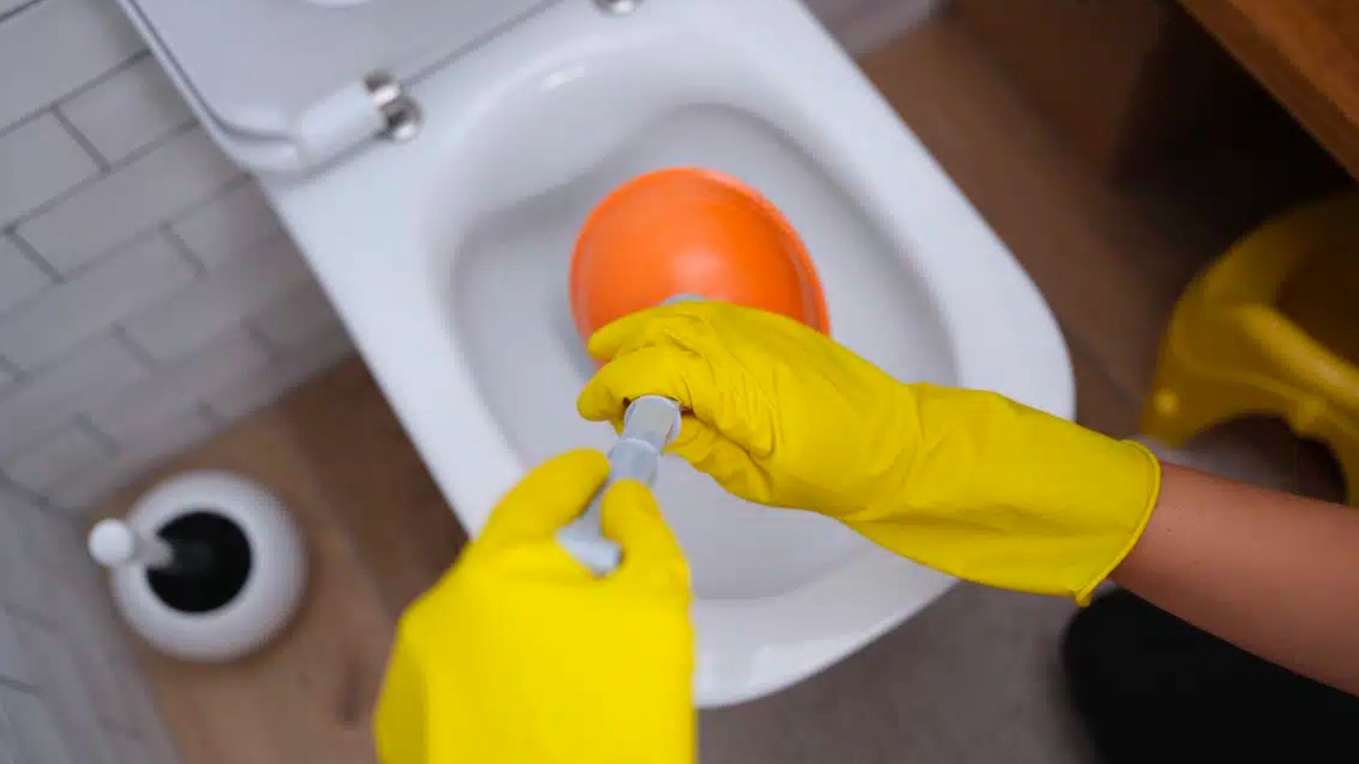 Orange Plunger Yellow Gloves