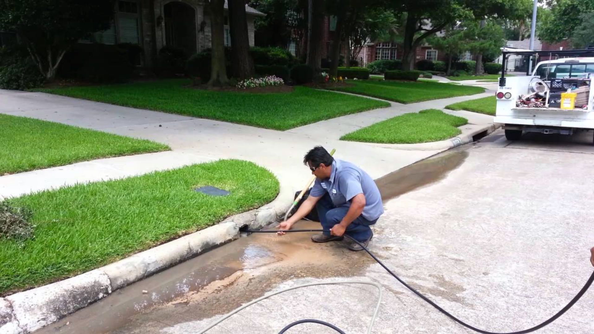 Man Pumping Water To Clear Clogged Drain